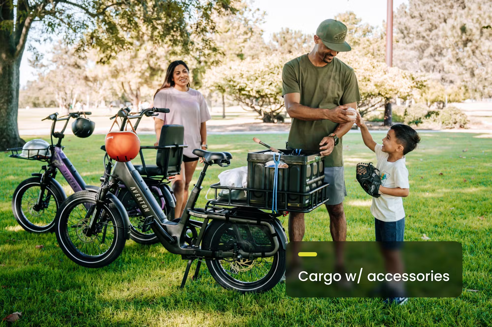 Rex E-Bikes Aventon Abound SR cargo e-bike parked on grass with family and cargo accessories