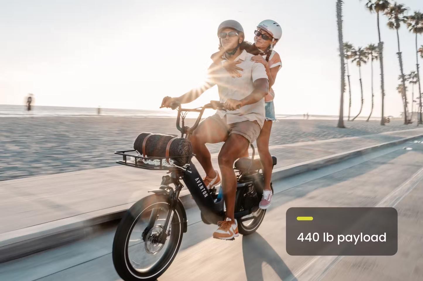 Rex E-Bikes Aventon Abound SR cargo e-bike ridden by two people with 440 lb payload on beach path