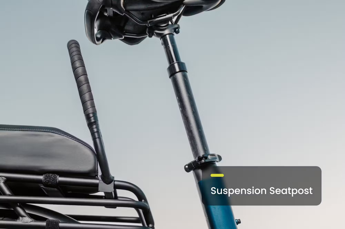 Close-up of suspension seatpost on Aventon Abound SR cargo e-bike by Rex E-Bikes in black and blue