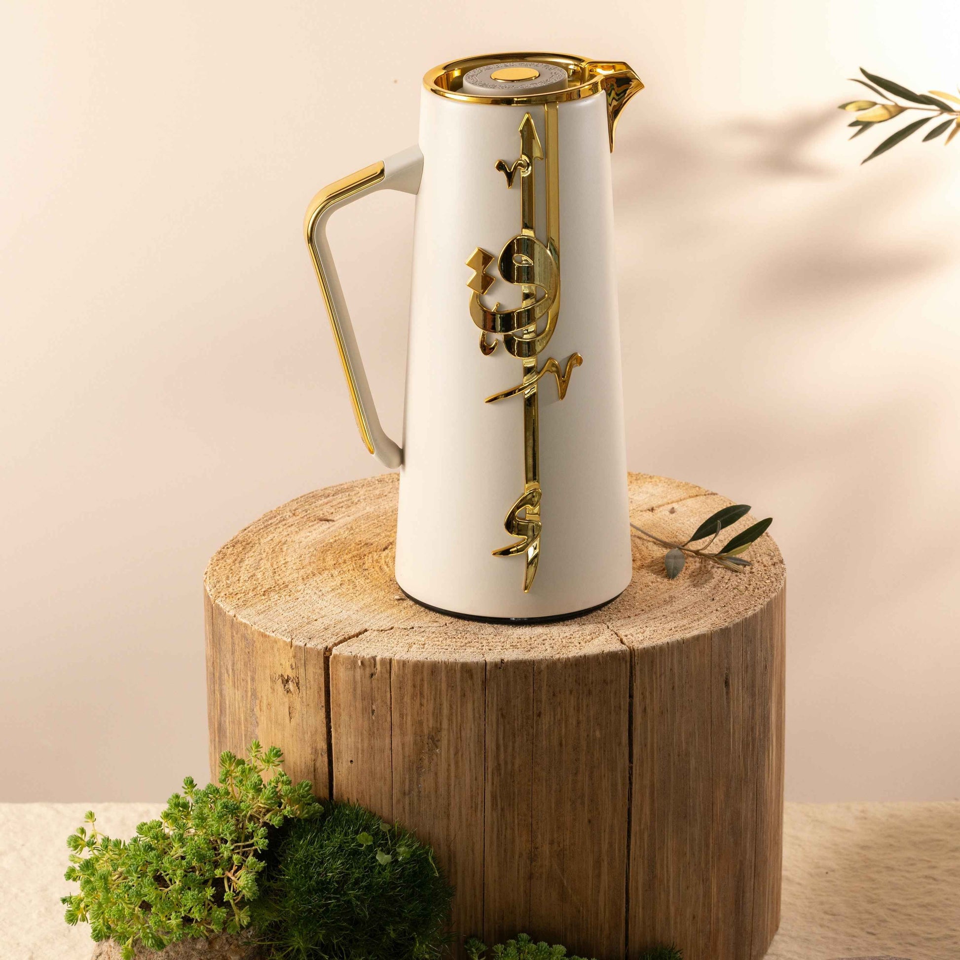 Otantik Home beige and gold vacuum flask with decorative gold accents on wooden surface