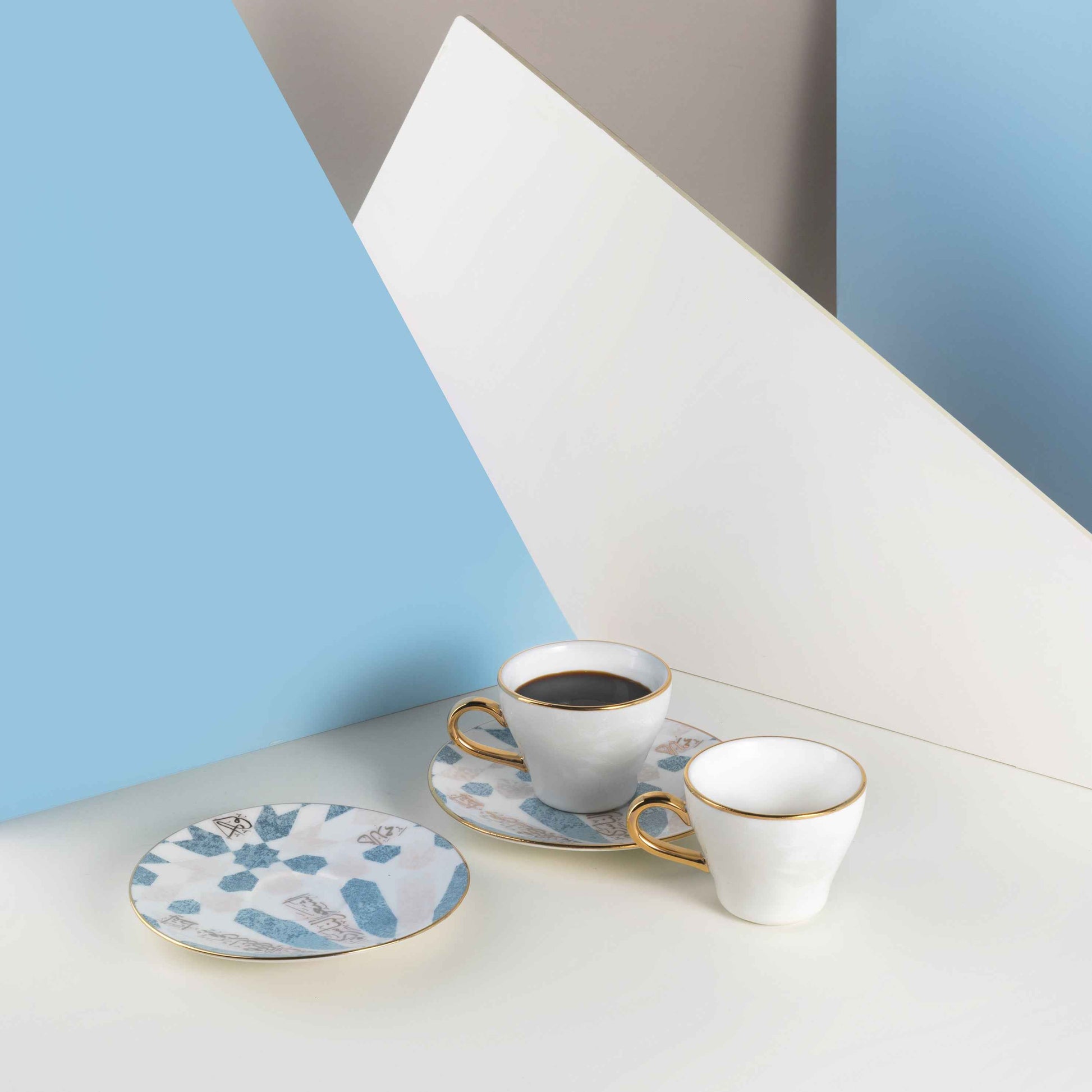 Otantik Home blue and gold espresso cups set with two cups and matching saucer on white surface