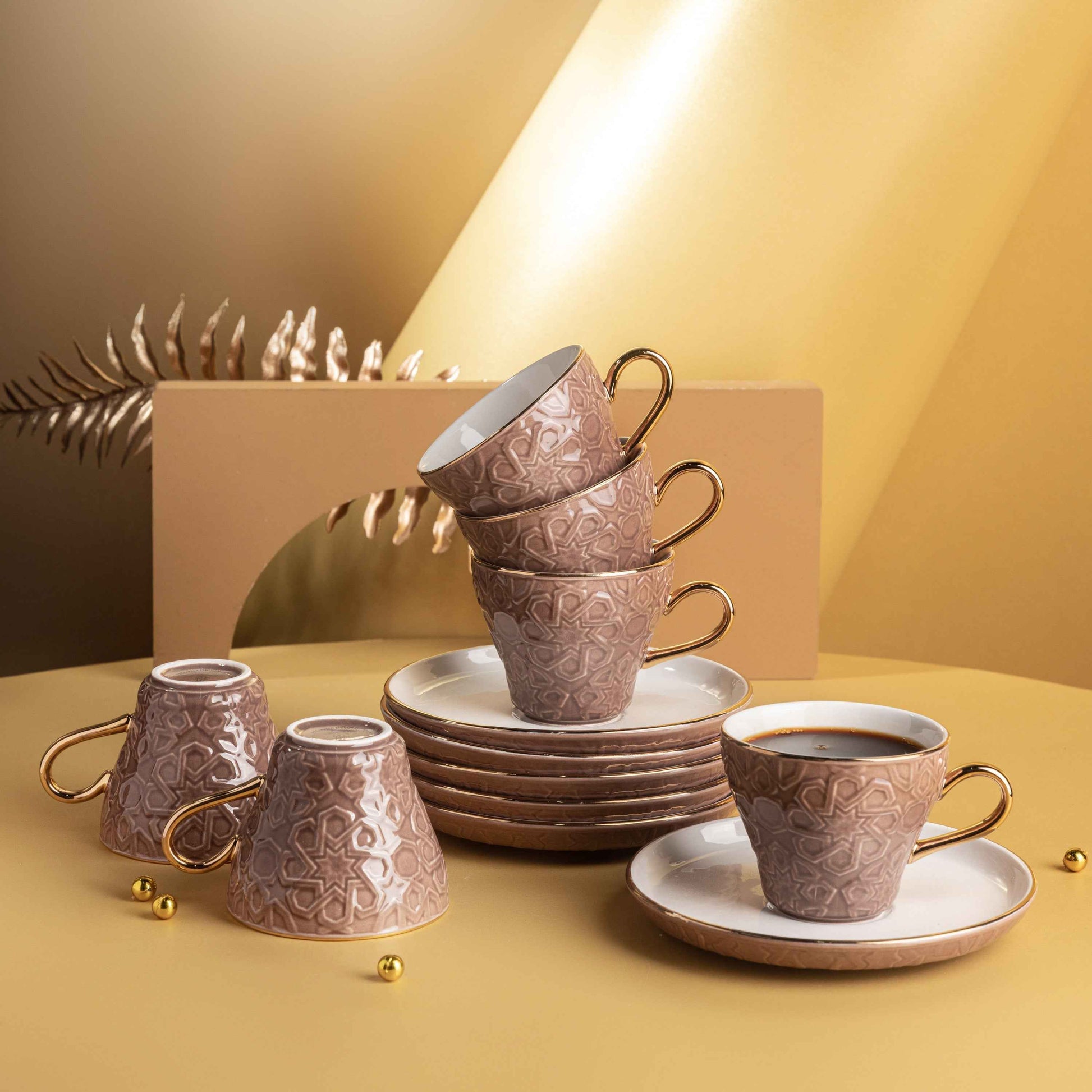 Brown and gold espresso cup set with intricate patterns including six cups and matching saucers