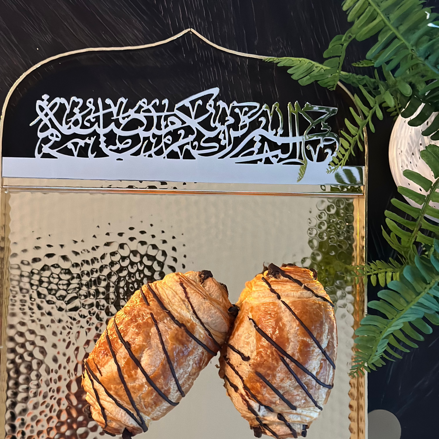 Otantik Home gold serving tray with hammered texture holding two chocolate drizzled croissants