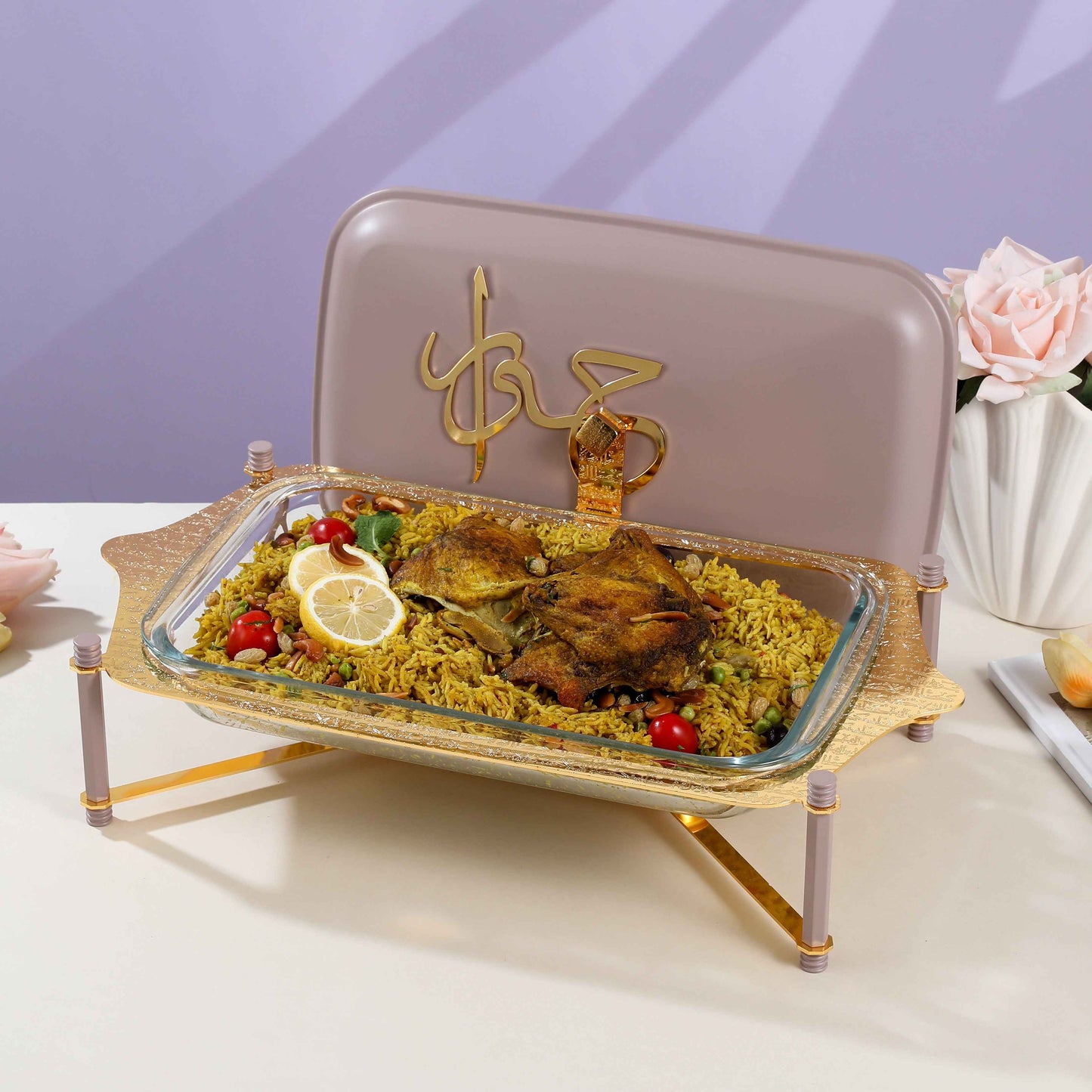Large Pyrex chafer with lid holding roasted chicken and rice on decorative gold stand