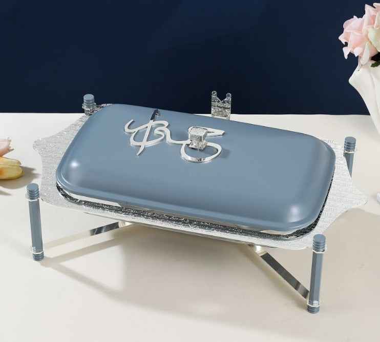 Otantik Home Pyrex candle chafer dish with a blue lid and silver stand on a white table