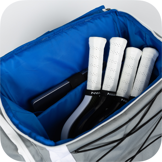 Interior view of Titan Pickleball Backpack showing multiple pickleball paddles with white grips inside