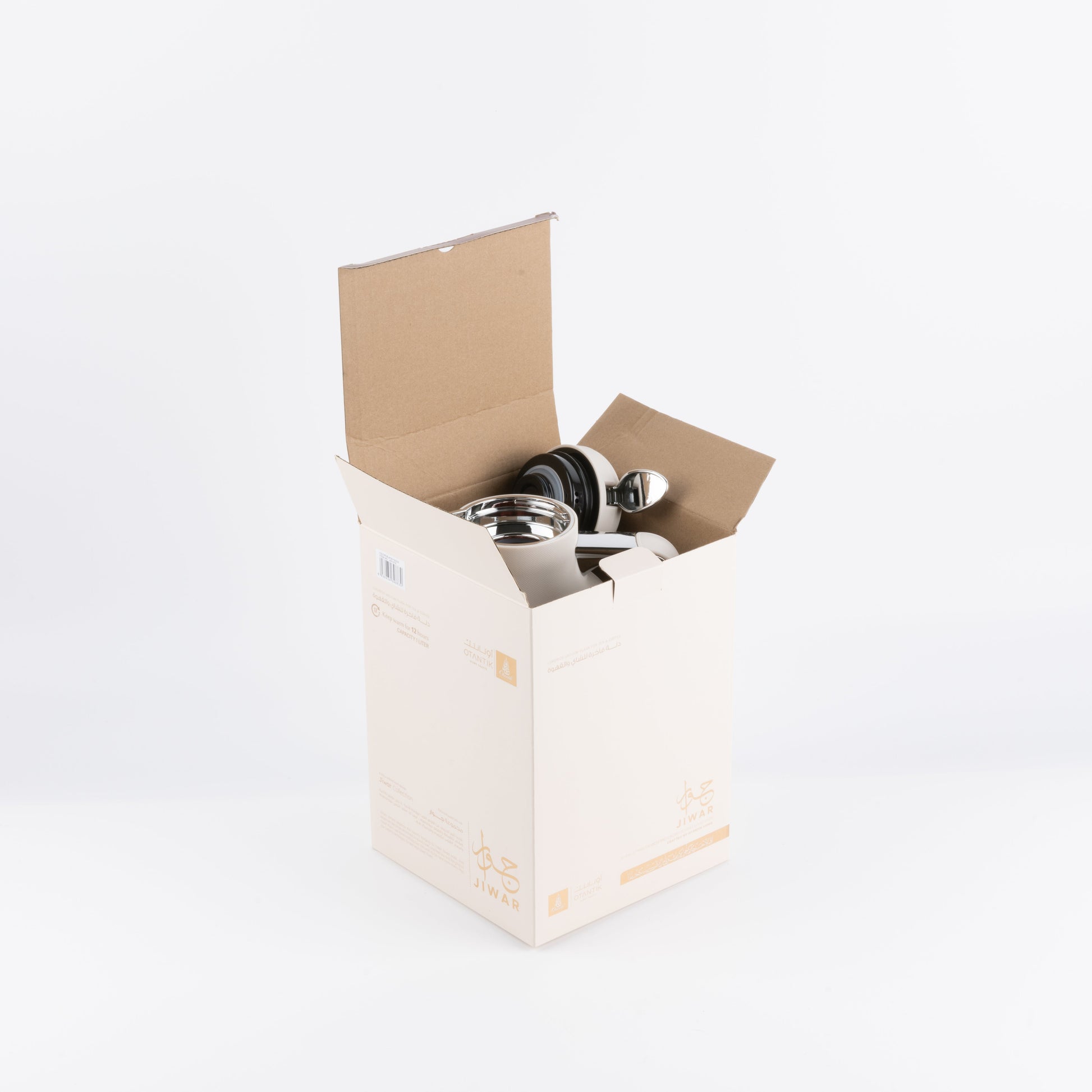 Beige vacuum flask from Otantik Home partially inside open beige packaging box with stainless steel lid
